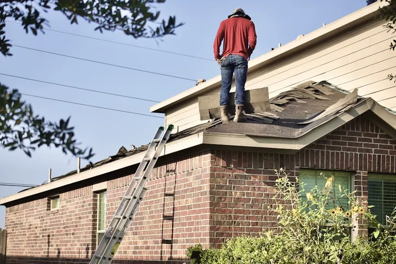 Professional roofer working on a residential roof in Festus